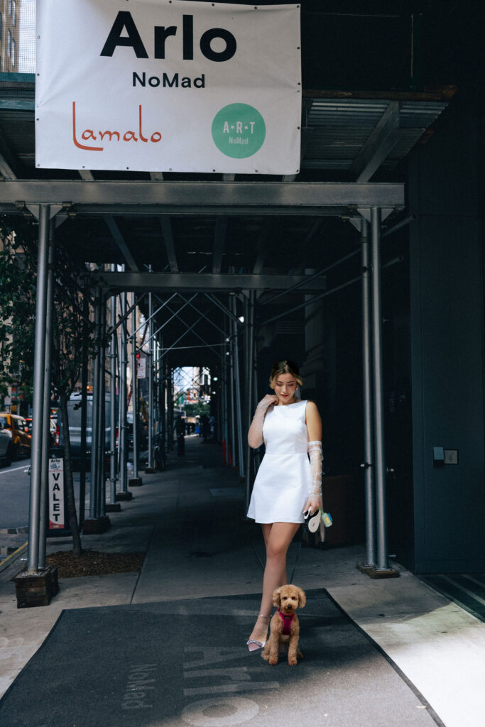 Bride standing outside the Arlo NoMad with her puppy, capturing a stylish and joyful pre-wedding moment in NYC