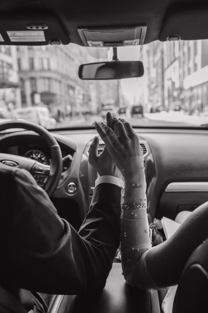 Couple holding hands on the way to City Hall, capturing a sweet and intimate moment before their wedding ceremony in NYC.