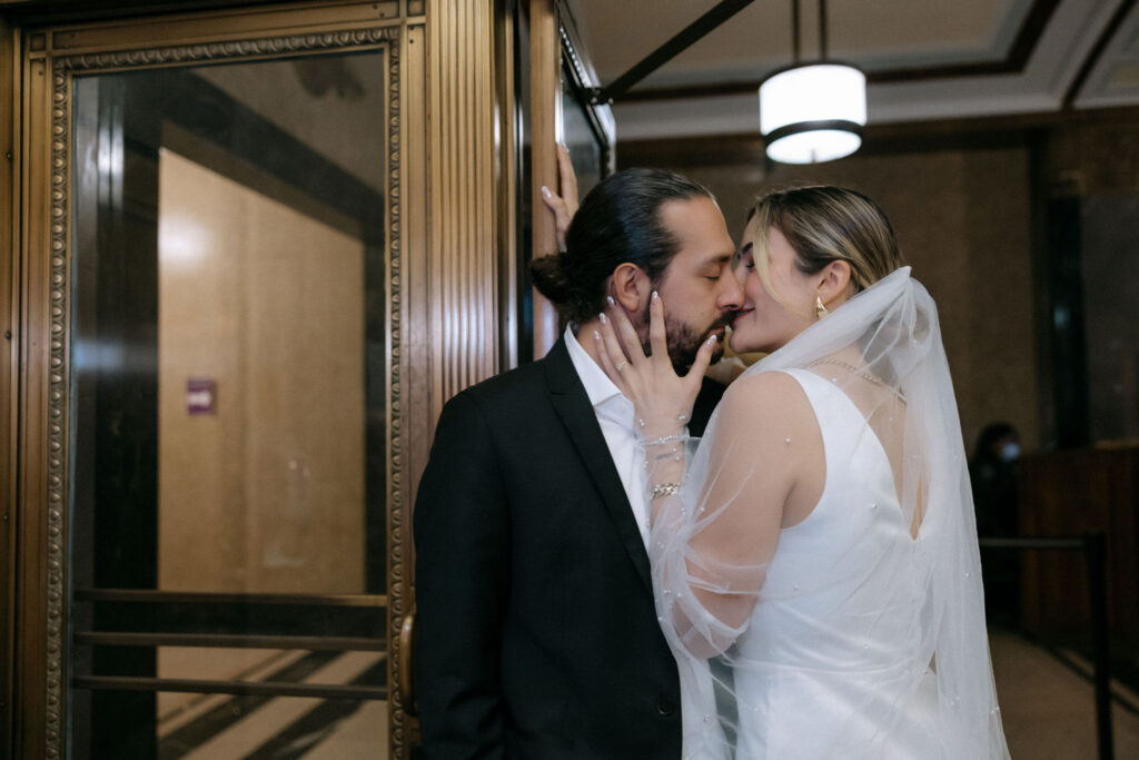 Couple sharing a kiss, capturing a romantic and intimate moment before their wedding.