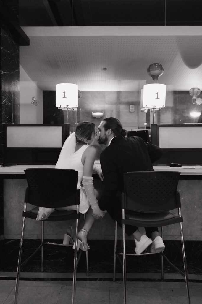 Couple signing the marriage papers at City Hall, capturing a significant moment during their wedding ceremony