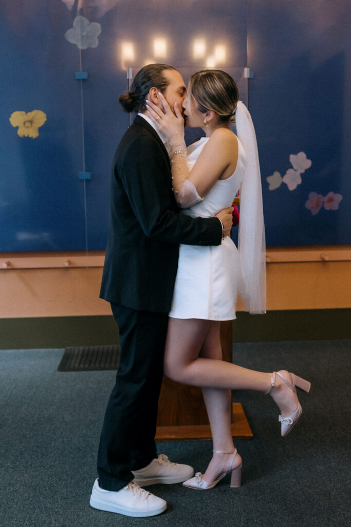 Couple sharing their first kiss as newlyweds during their City Hall wedding ceremony in Manhattan, NYC.