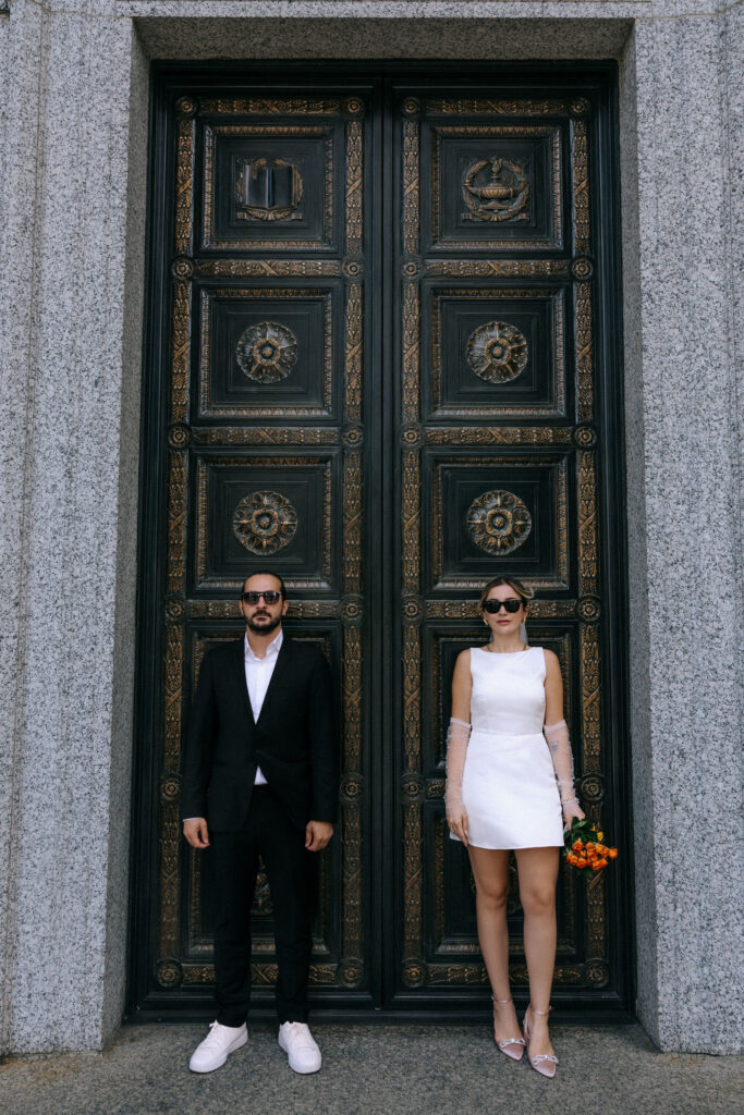 Couple celebrating after their City Hall wedding in Manhattan during a photoshoot, capturing romantic moments against the backdrop of NYC streets.