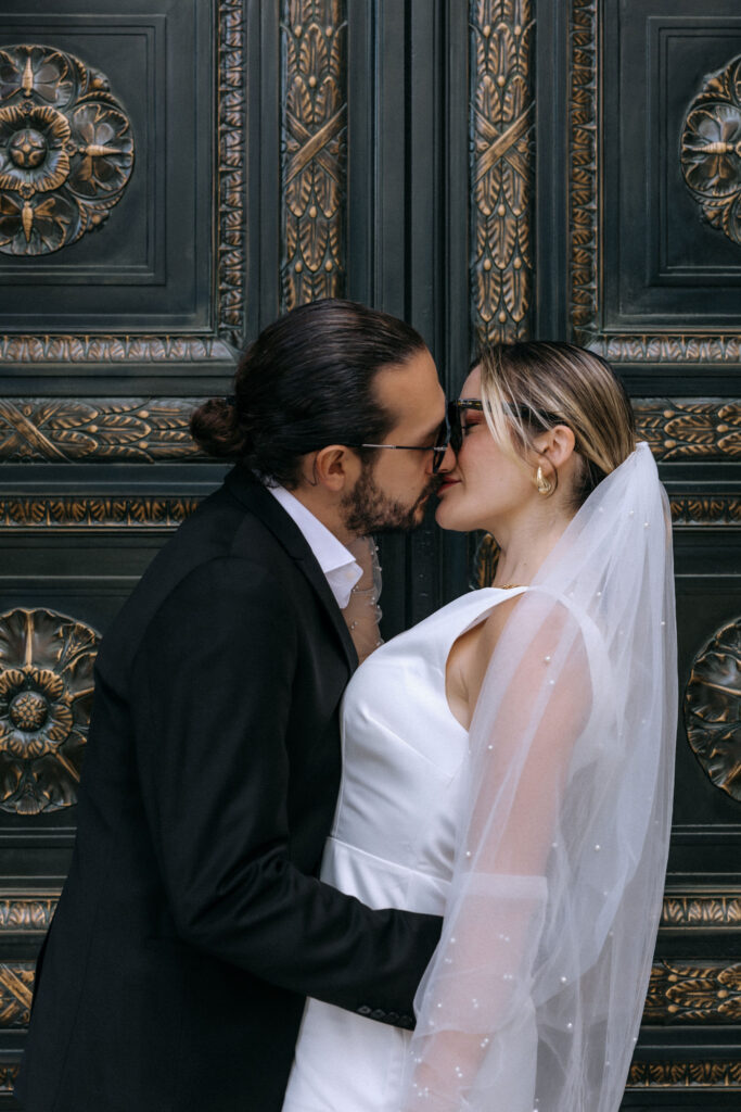 Newlywed couple enjoying a photoshoot in Manhattan after their City Hall wedding, with iconic NYC streets in the background.