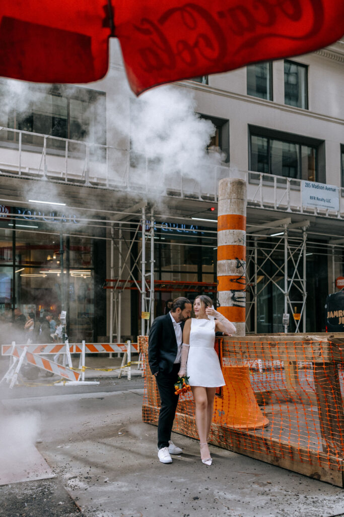 Unique wedding photos capturing a couple by the iconic NYC steam pipes, highlighting their love against the backdrop of the city's vibrant urban landscape