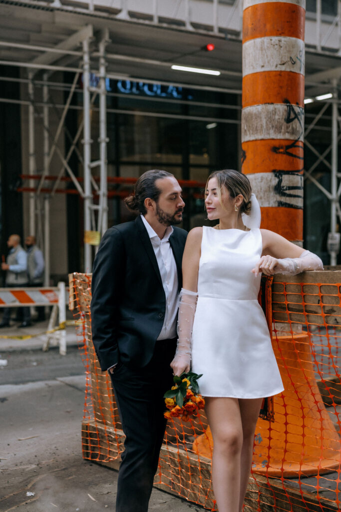 Distinctive wedding photos of a couple by the iconic NYC steam pipes, featuring candid moments that reflect their love in the heart of New York City
