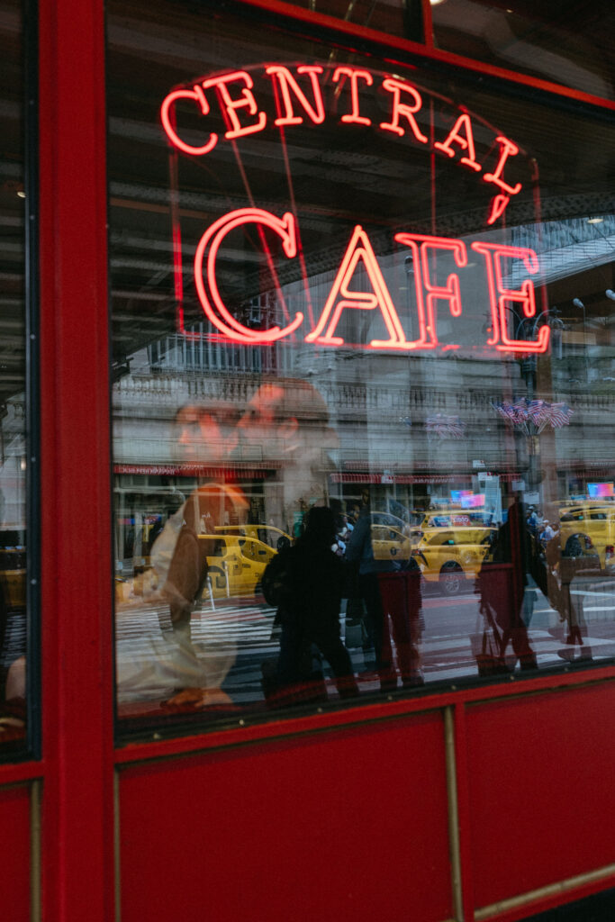 Newlyweds enjoying a cinematic moment at Central Café, capturing their love in a cozy and romantic NYC setting