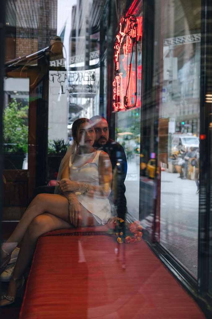 Newlywed couple sharing a tender moment at Central Café, featuring a cinematic vibe that highlights their love in a charming NYC atmosphere.