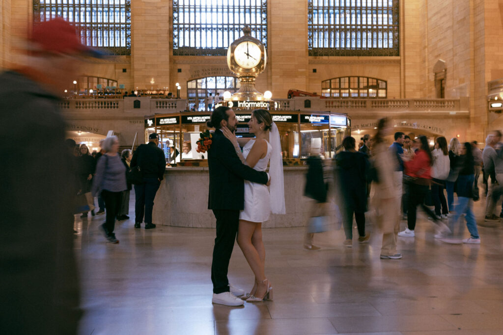 Motion blur of a couple walking through Grand Central Terminal, capturing the bustling energy and iconic architecture of NYC