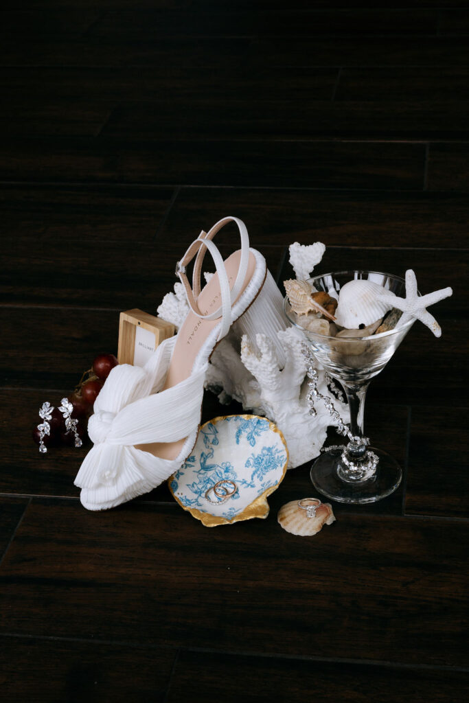 Creative wedding detail shot with elegant bridal shoes, showcasing luxury style and personalized touches for an intimate, romantic wedding.
