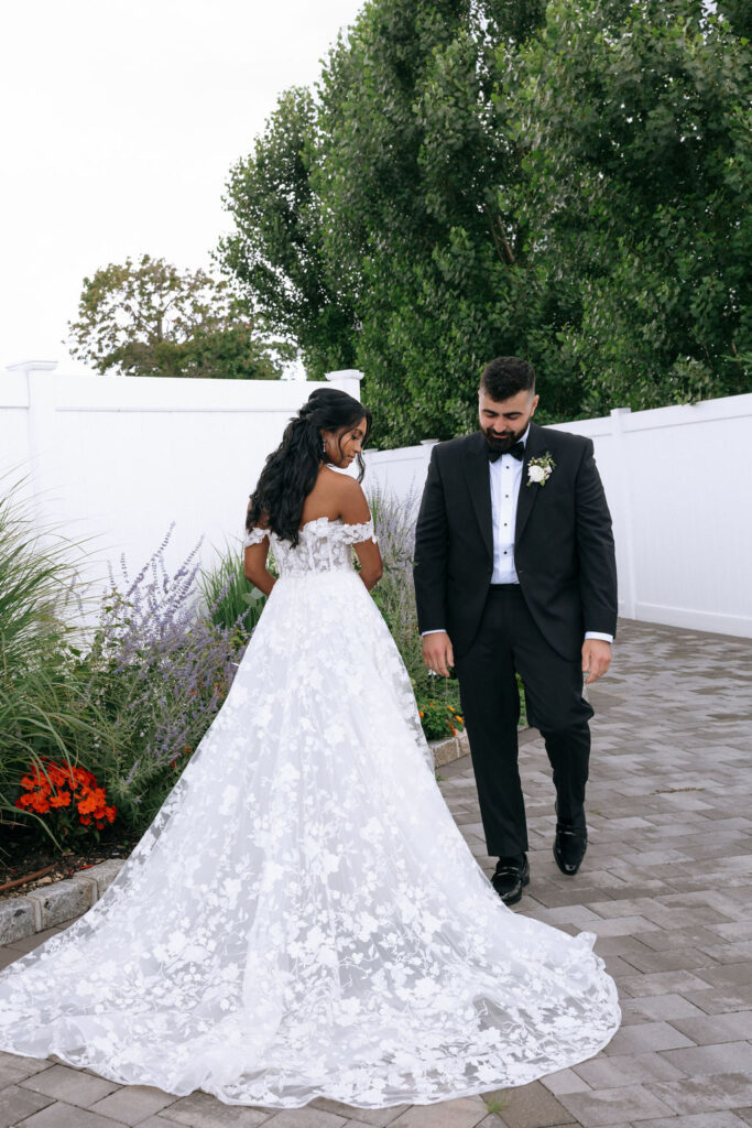 Candid first look of bride and groom, capturing their excitement and love before their romantic wedding celebration.
