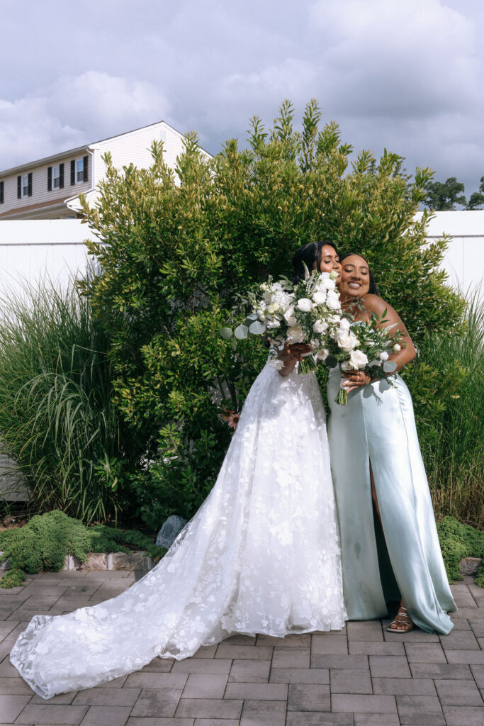 Bride and maid of honor standing side by side, posed with elegant bouquets, celebrating their friendship and the special wedding day