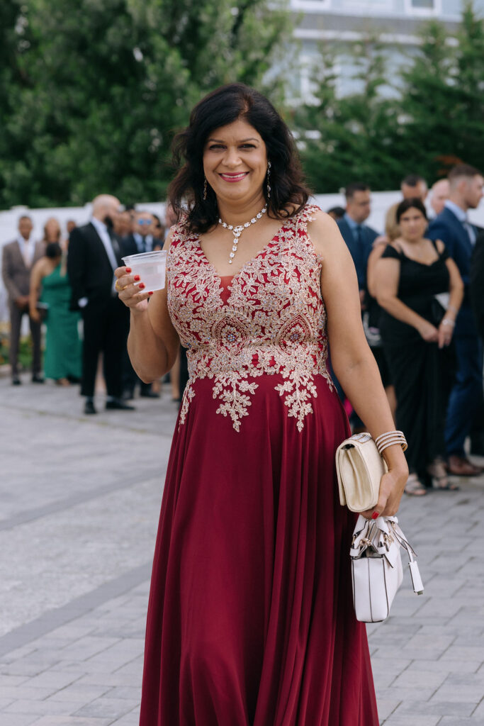 Candid shot of wedding guests arriving, highlighting the excitement and joyful atmosphere as they gather for the ceremony