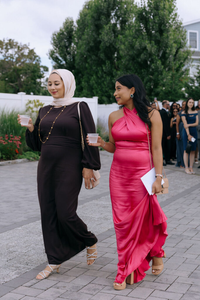 Guests arriving at the intimate wedding ceremony, dressed elegantly and sharing joyful conversations before the celebration begins