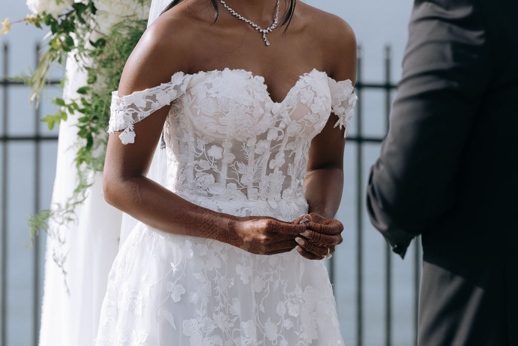 Bride and groom exchanging rings during their wedding ceremony, capturing a symbolic and emotional moment of commitment and love