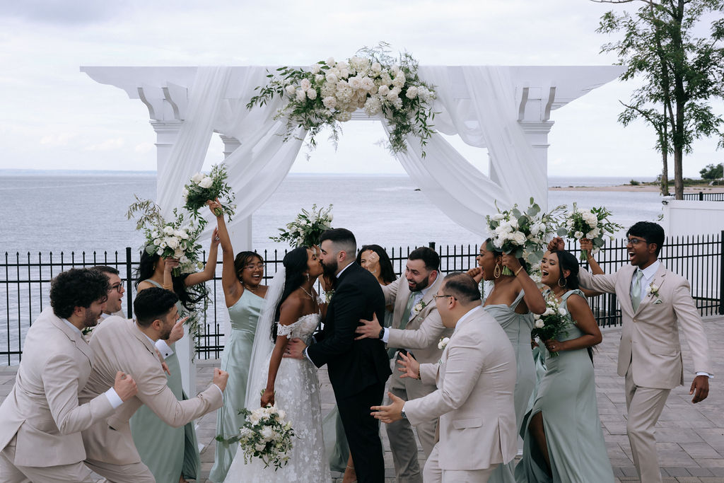 Bridal party posed in a spontaneous, joyful moment, with everyone laughing and enjoying a fun pre-wedding celebration.
