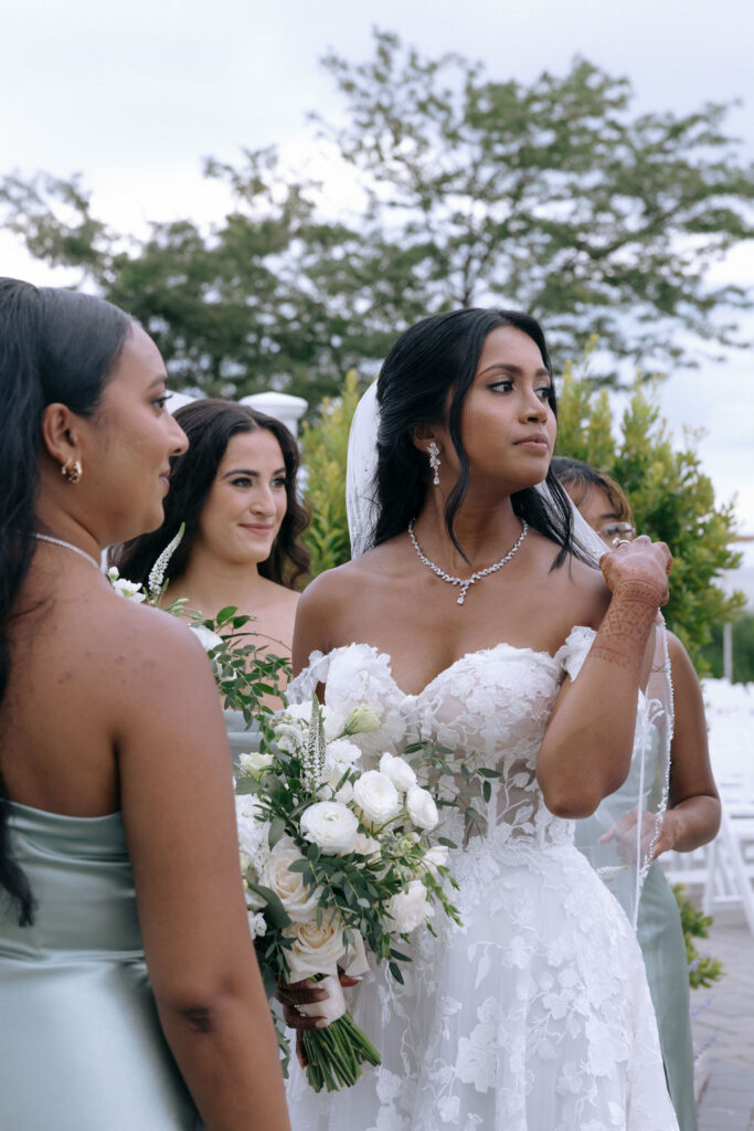 Bridal party candidly interacting, sharing genuine smiles and excitement before the wedding ceremony, showcasing a joyful and relaxed vibe
