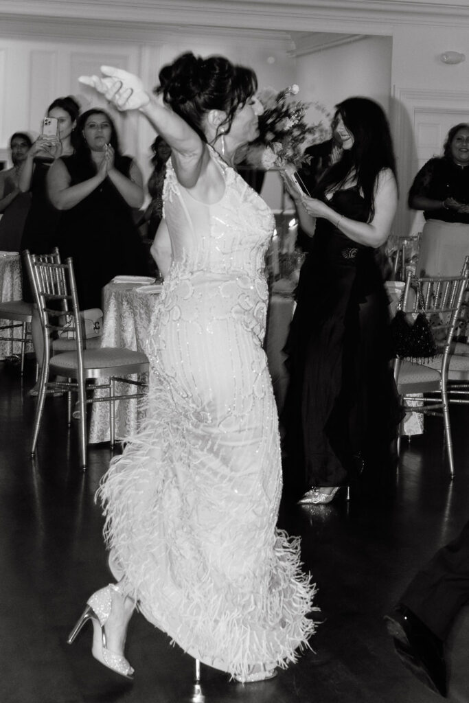 Groom's mother dancing at the wedding reception, sharing a joyful and heartfelt moment on the dance floor
