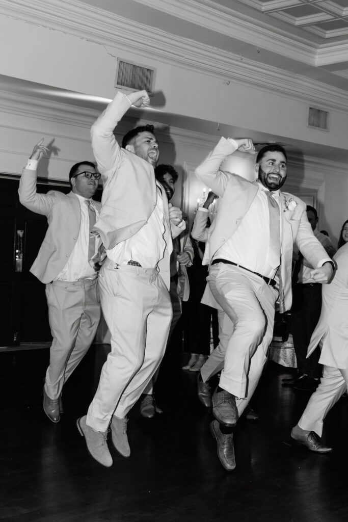 Bridal party dancing into the reception, bringing fun and excitement as they celebrate the newlyweds.
