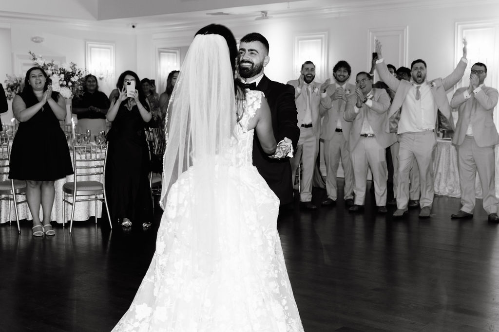 Bride and groom sharing a romantic first dance, captured in an intimate and emotional moment on the wedding reception dance floor.
