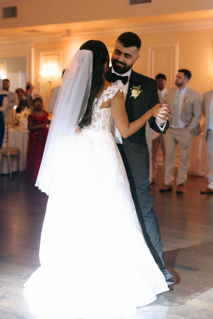 Bride and groom enjoying their first dance as a married couple, creating a romantic and unforgettable moment at the wedding reception