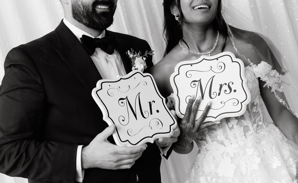 Bride and groom sharing a fun and playful moment, laughing and enjoying their wedding day together