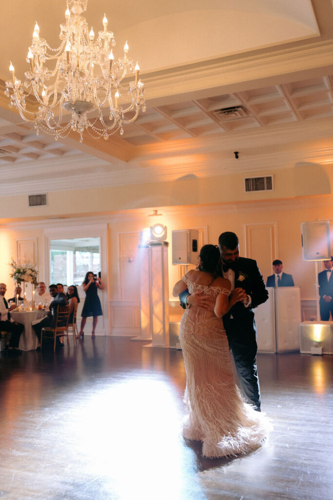 Groom dancing with his mother, sharing a joyful and emotional moment on the wedding dance floor