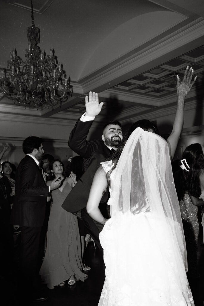 Bride and groom dancing together on the dance floor, celebrating their love and creating unforgettable memories during their wedding reception.