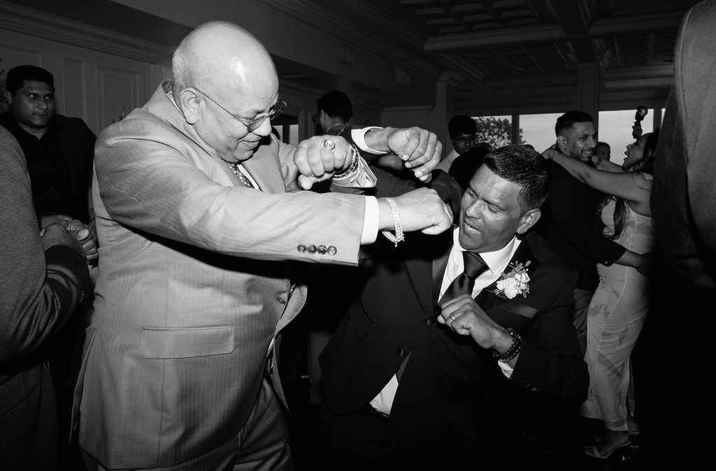 Dad dancing with friends and family on the dance floor, adding to the fun and festive spirit of the wedding celebration.