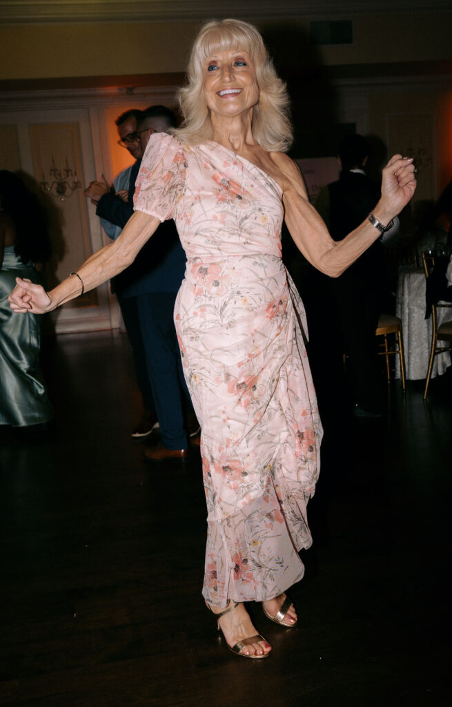 Grandma joyfully dancing at the wedding reception, celebrating with family and showcasing her vibrant spirit.