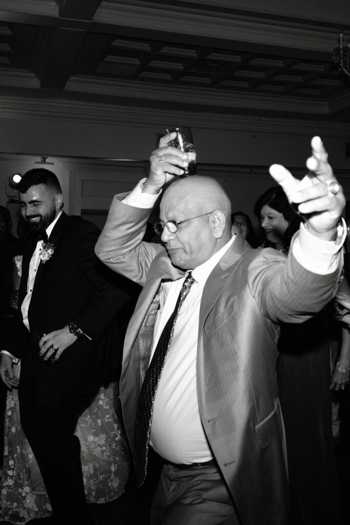 Wedding guest dancing joyfully on the dance floor, capturing the fun and excitement of the celebration