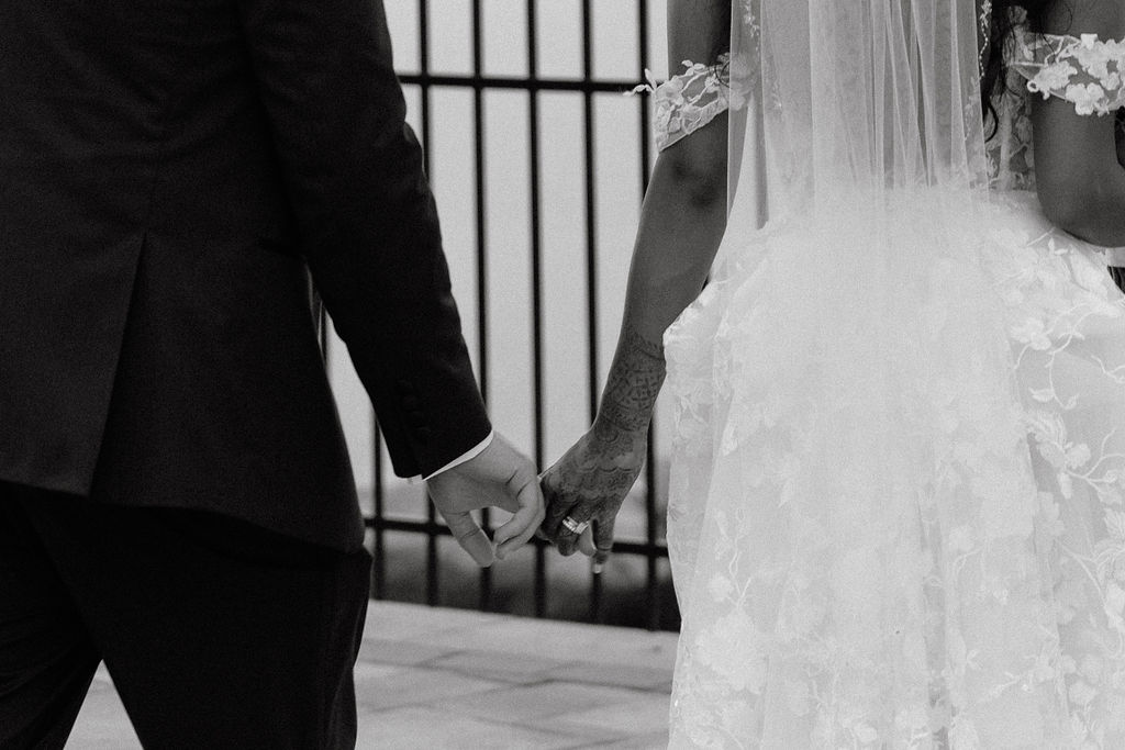 Couple holding hands, symbolizing their love and connection during a romantic moment at sunset.