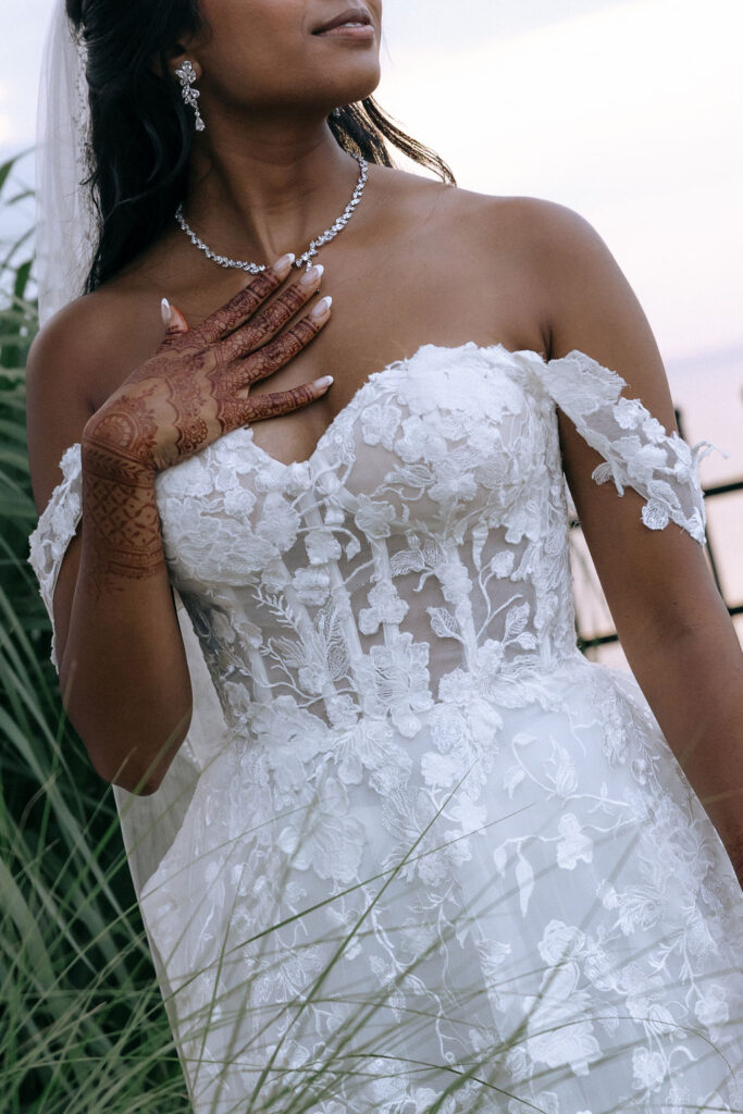 Close-up of the bride's hand adorned with intricate Indian henna designs, showcasing beautiful wedding details and cultural artistry