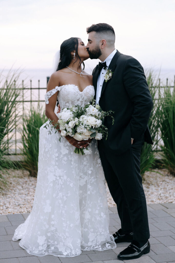 Couple sharing a passionate kiss, capturing a beautiful moment of love and connection on their wedding day