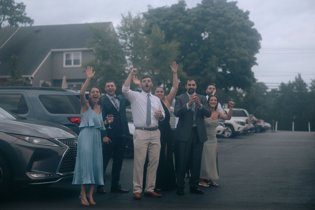 Guests cheering and celebrating as the couple makes their grand entrance back to the wedding reception, creating a joyful and lively atmosphere.