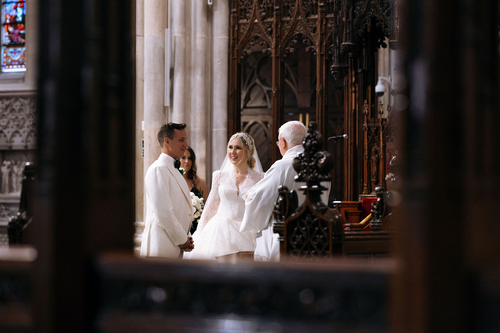 A bride and groom exchanging vows during their intimate NYC cathedral wedding ceremony.