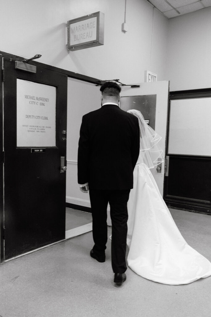 Bride and groom walking into the Brooklyn City Hall Marriage Bureau for their elopement ceremony.