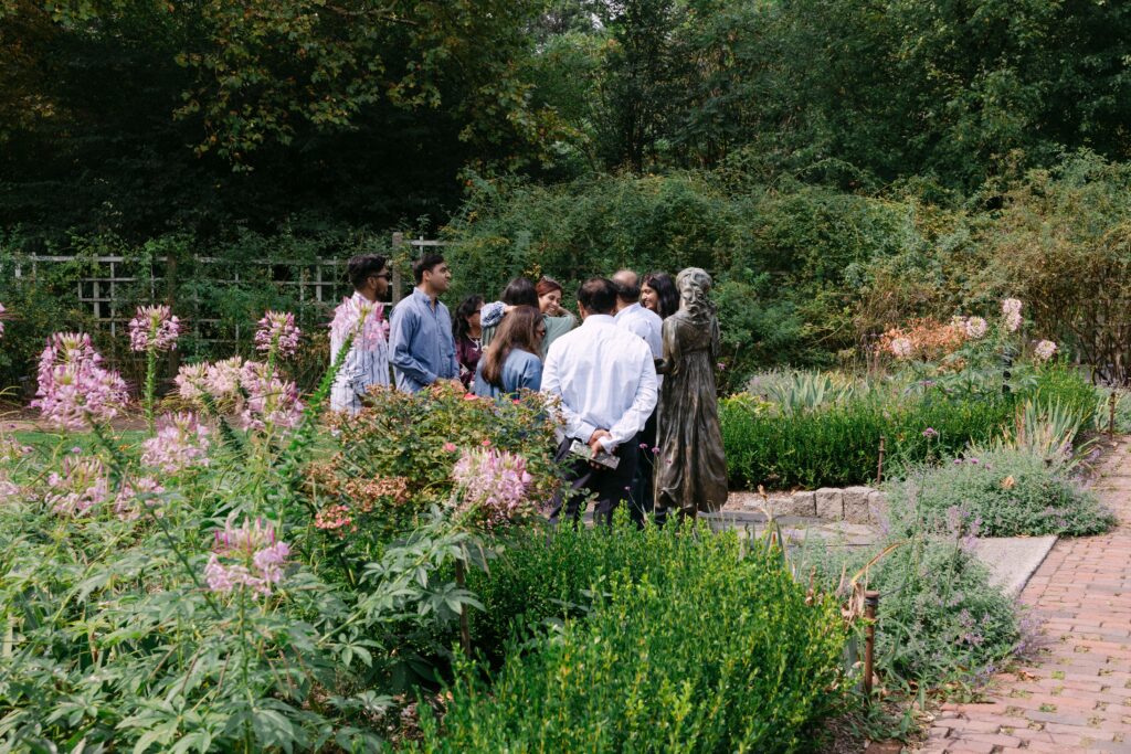 Family and friends gathered in the Rose Garden at Brooklyn Botanic Garden to celebrate a surprise proposal, photographed by NYC engagement photographer.
