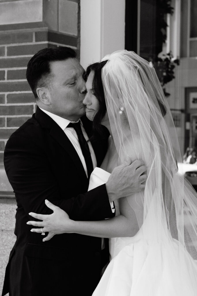 Bride and groom sharing a kiss outside during a SoHo wedding in New York City