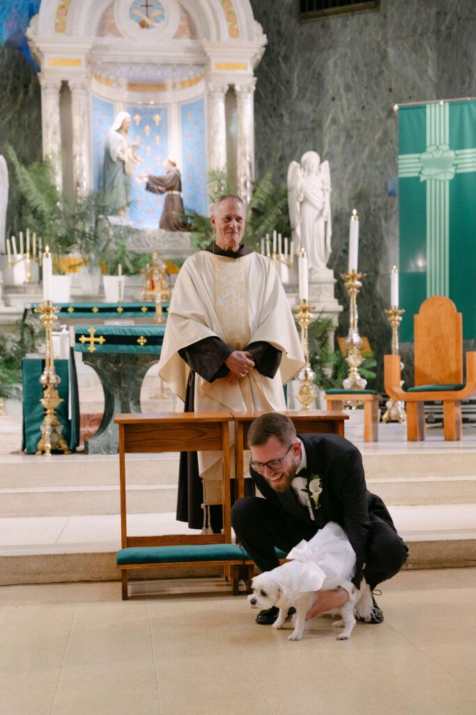 Bride kneeling with her dog during an intimate SoHo wedding ceremony in New York City
