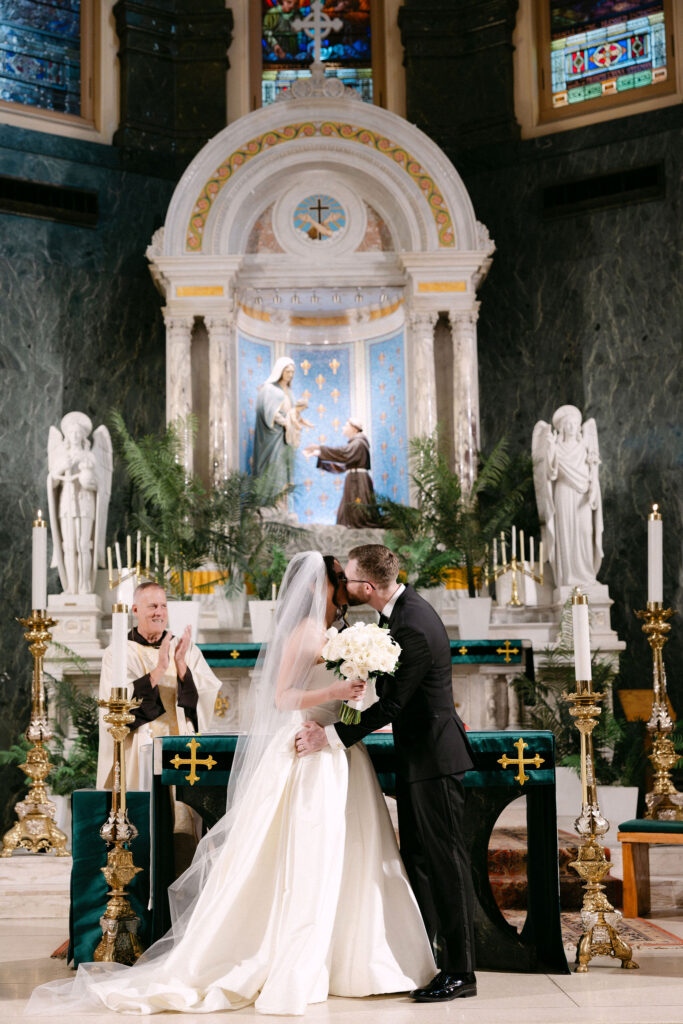 Bride and groom standing at the altar during their wedding ceremony in a historic SoHo church in New York City