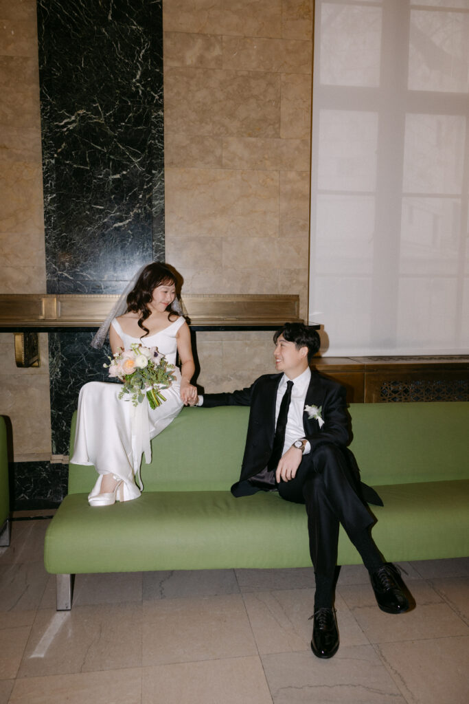 Just married couple sitting together inside NYC City Hall