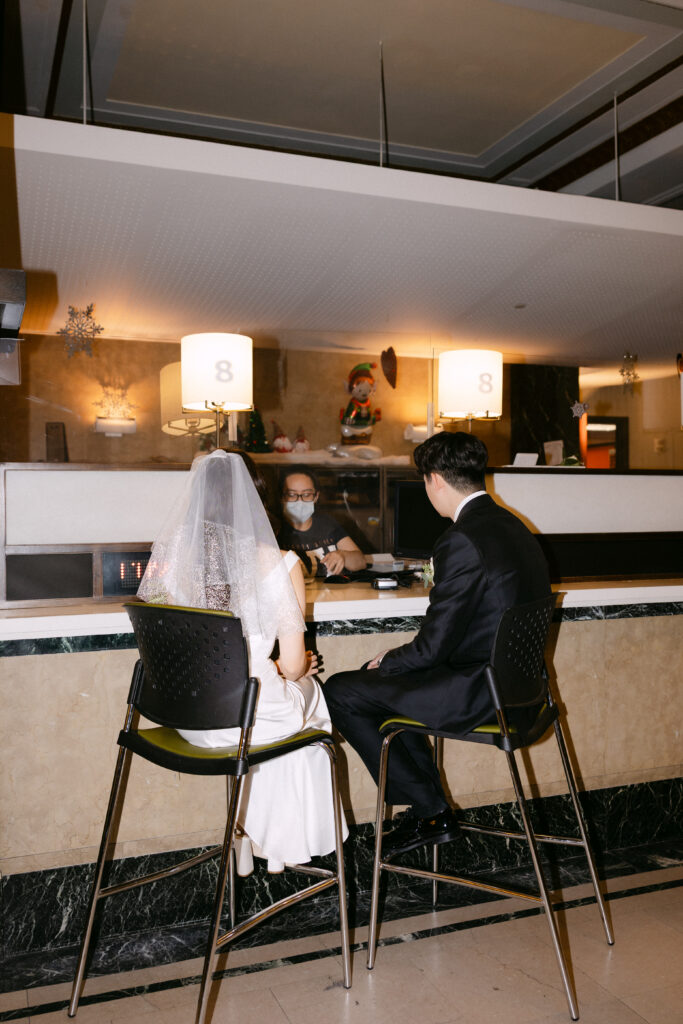 Just married couple sitting together at a bar after their city hall wedding