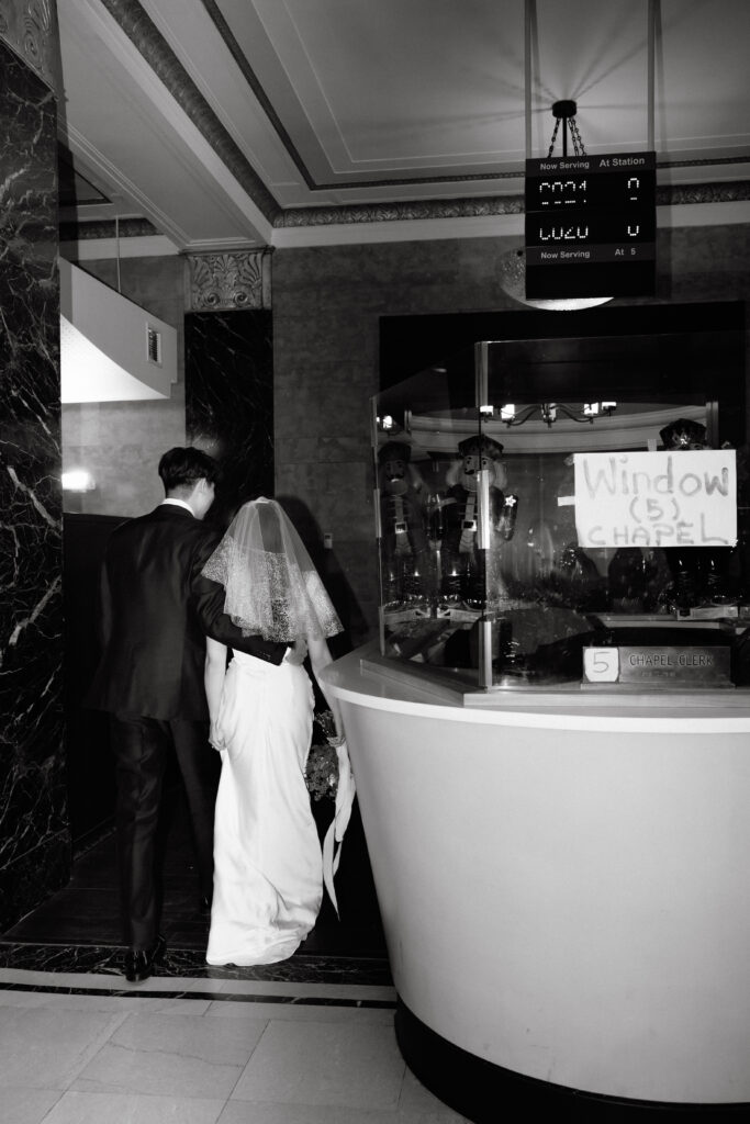 Couple standing together at a bar after their city hall wedding