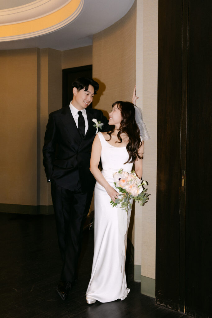Couple standing together indoors after their city hall wedding