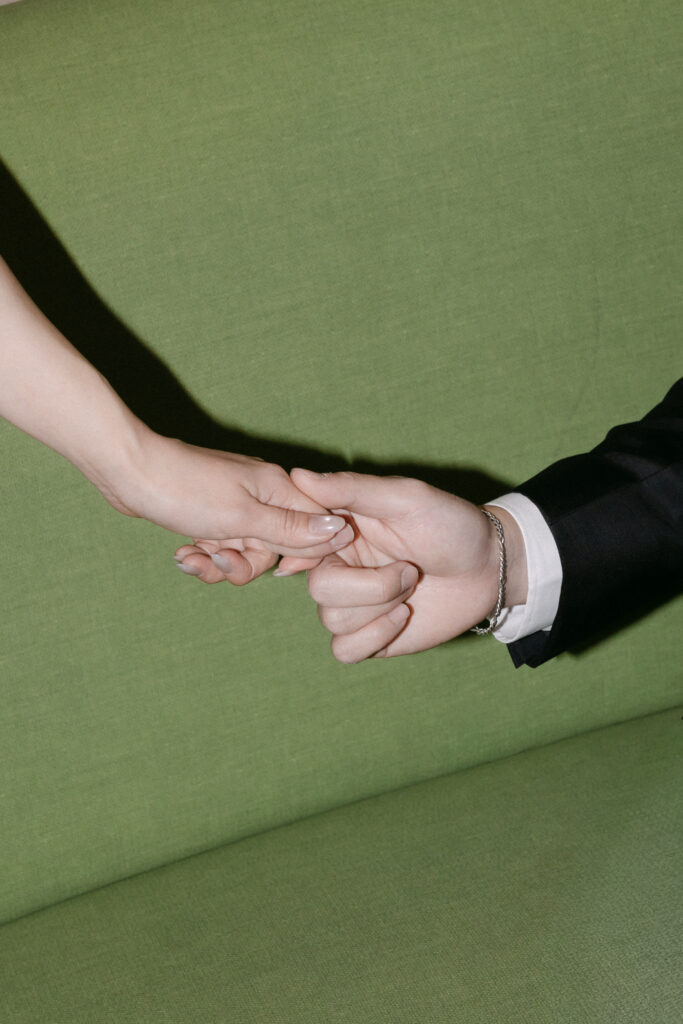 Close-up of a couple holding hands inside NYC City Hall