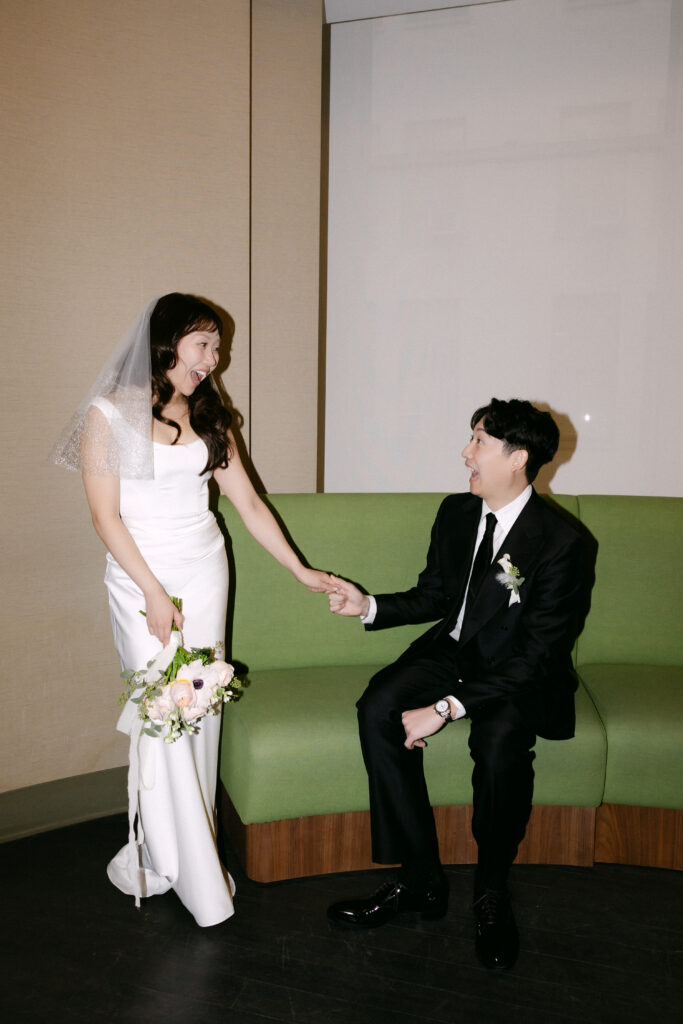 Bride and groom holding hands inside NYC City Hall