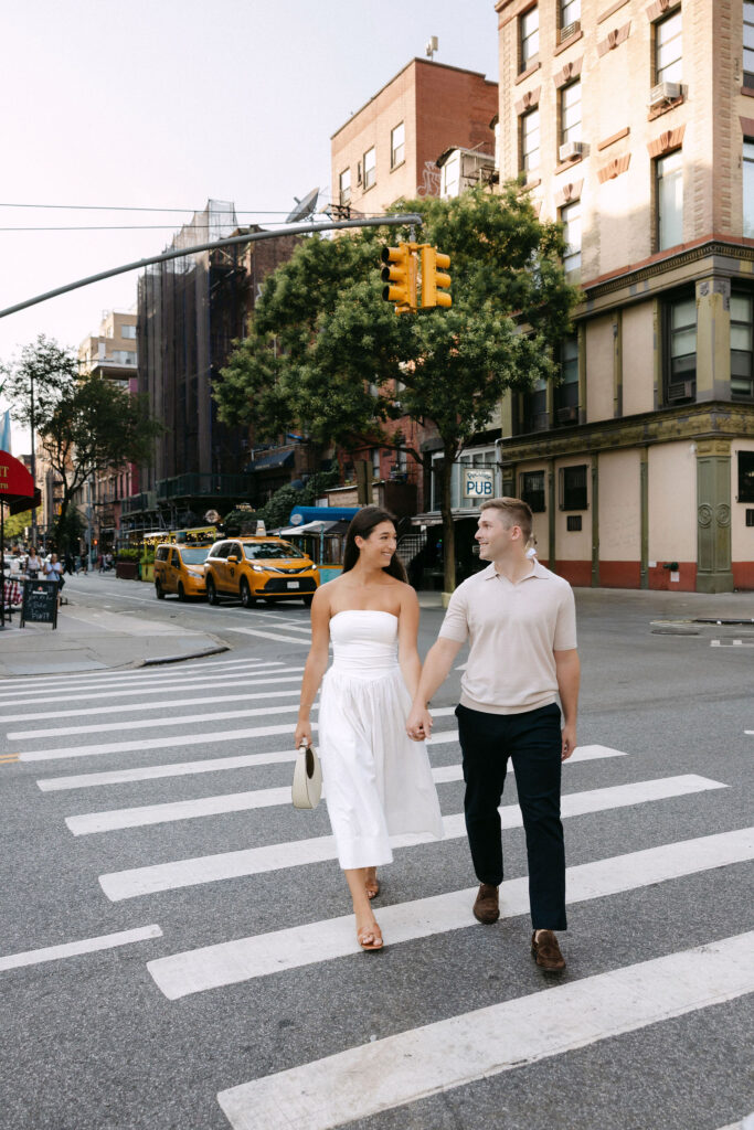 west village engagement photos of a couple crossing the street in new york city