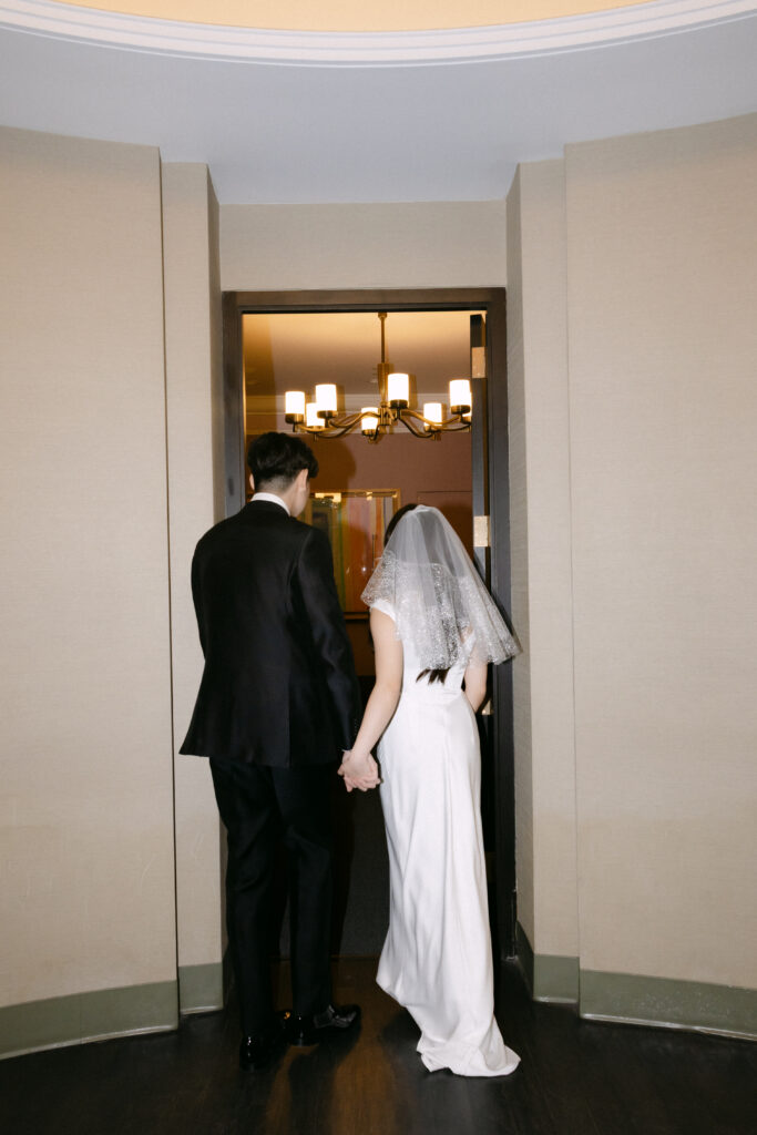 Couple standing together in a doorway inside NYC City Hall