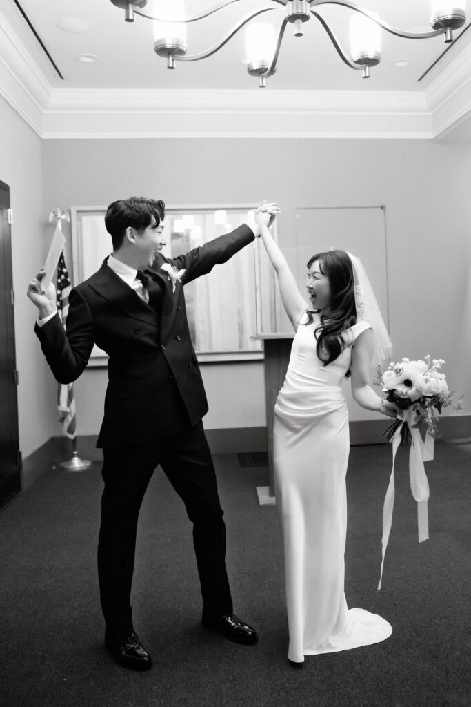 Couple interacting playfully inside NYC City Hall