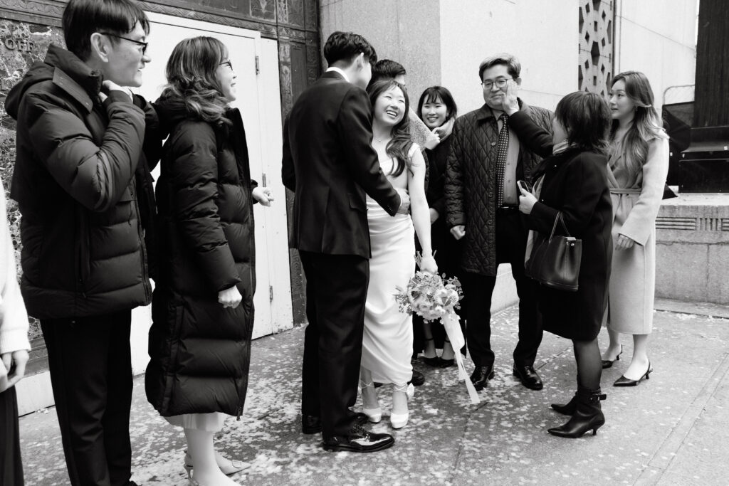 Family and friends gathered outside NYC City Hall after wedding